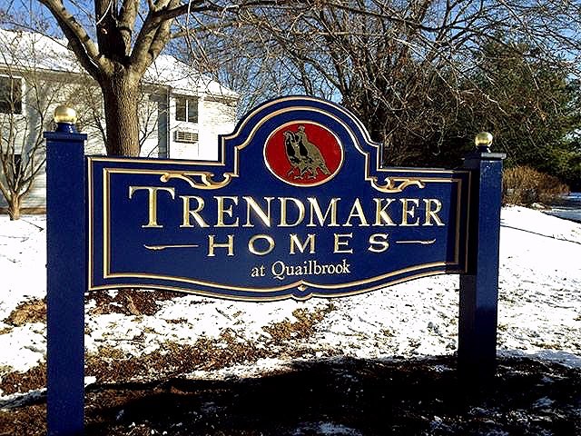 Blue Trendmaker Homes carved sign with gold leaf lettering and logo insignia - Contact Royce Signworks